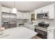Modern kitchen with white cabinets, stainless steel appliances, quartz countertops and subway tile backsplash at 1118 Brookwood Dr, Stanley, NC 28164
