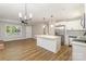 Open living space features a modern kitchen, stainless appliances, island, and views of the front yard at 1118 Brookwood Dr, Stanley, NC 28164