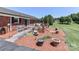 Brick patio with wheelchair ramp, fountain, landscaping and views of the manicured backyard at 116 Deer Trail Rd, Statesville, NC 28677