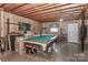 Unfinished basement space featuring a pool table, storage, and natural light at 116 Deer Trail Rd, Statesville, NC 28677