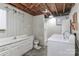 Basement bathroom features a shower, vanity, toilet, and a washer and dryer at 116 Deer Trail Rd, Statesville, NC 28677