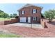 Rear view of a two-story brick house with a two-car garage and a parking pad at 116 Deer Trail Rd, Statesville, NC 28677
