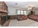 Comfortable living room with brick fireplace and neutral carpet at 116 Deer Trail Rd, Statesville, NC 28677