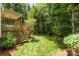 Serene backyard view with a deck overlooking the lush lawn and mature trees at 11624 Crossroads Pl, Concord, NC 28025