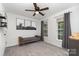 Bedroom with a bench by the windows, complemented by gray carpet and modern decor at 11624 Crossroads Pl, Concord, NC 28025