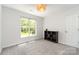 Comfortable bedroom with gray carpet, a window, ceiling light, and a dark bookshelf at 11624 Crossroads Pl, Concord, NC 28025