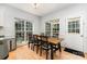Bright dining area with hardwood floors, wooden table, and natural light at 11624 Crossroads Pl, Concord, NC 28025