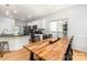 Cozy dining area with hardwood floors, kitchen view, and bright natural light at 11624 Crossroads Pl, Concord, NC 28025