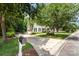 Lovely suburban home featuring a long driveway, manicured lawn, mature trees, and a charming mailbox at 11624 Crossroads Pl, Concord, NC 28025