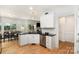 Open kitchen offers stainless appliances, granite counters and bright adjacent dining at 11624 Crossroads Pl, Concord, NC 28025