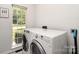 Convenient laundry room with washer and dryer and natural light at 11624 Crossroads Pl, Concord, NC 28025