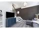 Cozy living room with staircase features plush gray carpet and a modern light fixture at 11624 Crossroads Pl, Concord, NC 28025
