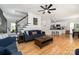 Open-concept living area with hardwood floors, staircase, and a view into the kitchen at 11624 Crossroads Pl, Concord, NC 28025