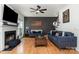Cozy living room with hardwood floors, fireplace, dark accent wall, and comfortable blue sofas at 11624 Crossroads Pl, Concord, NC 28025