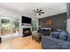 Comfortable living room with hardwood floors, fireplace, and large windows at 11624 Crossroads Pl, Concord, NC 28025