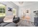 Bright home office offers large windows, French doors, and comfortable gray sectional at 11624 Crossroads Pl, Concord, NC 28025