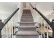 Carpeted staircase with dark wood railing connects multiple levels of the home at 11624 Crossroads Pl, Concord, NC 28025