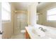 Bathroom features white vanity, toilet, shower with glass doors, and natural light at 1280 Queensgate St, Gastonia, NC 28054