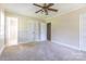 Bedroom with neutral carpeting, ceiling fan, and access to en-suite bathroom and closet at 1280 Queensgate St, Gastonia, NC 28054