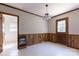 Dining room features wood paneled walls and an exposed doorway to a bedroom at 1280 Queensgate St, Gastonia, NC 28054