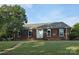 Charming brick home featuring a well-manicured lawn and classic architectural details at 1280 Queensgate St, Gastonia, NC 28054
