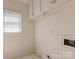 Small laundry room features cabinets and hookups at 1280 Queensgate St, Gastonia, NC 28054