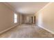 Spacious living room featuring neutral walls, carpet, and stairway at 1280 Queensgate St, Gastonia, NC 28054