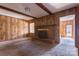 Living room with brick fireplace, wood paneled walls and exposed wood beams at 1280 Queensgate St, Gastonia, NC 28054