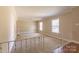 Bright living room featuring neutral walls, carpet, and natural light from two windows at 1280 Queensgate St, Gastonia, NC 28054