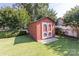 Backyard storage shed on a lush green lawn with mature landscaping at 1280 Queensgate St, Gastonia, NC 28054