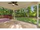 Inviting back porch with ceiling fan, offering a tranquil view of the lush backyard and surrounding trees at 1313 Western Hills Ln, Vale, NC 28168