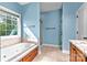Bathroom featuring a garden tub, walk-in shower, and tile floors at 1313 Western Hills Ln, Vale, NC 28168