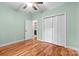 Bedroom with hardwood floors, closet, and a ceiling fan at 1313 Western Hills Ln, Vale, NC 28168