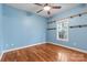 Bright bedroom featuring hardwood floors, open shelves, and a ceiling fan at 1313 Western Hills Ln, Vale, NC 28168