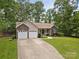 Charming ranch-style home boasts a manicured lawn, mature trees, and a two-car garage, perfect for suburban living at 1313 Western Hills Ln, Vale, NC 28168