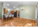 Open-concept kitchen and dining area features hardwood floors and a breakfast bar with seating at 1313 Western Hills Ln, Vale, NC 28168
