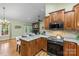 Well-appointed kitchen with stone countertops, stainless steel appliances, and open access to the living area at 1313 Western Hills Ln, Vale, NC 28168