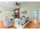 Stylish living room boasts a stone fireplace, hardwood floors, and neutral decor creating a cozy atmosphere at 1313 Western Hills Ln, Vale, NC 28168