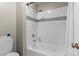 Bathroom featuring tub and shower with white subway tile and decorative accent tiles at 1420 11Th Street Nw Dr # 15, Hickory, NC 28601