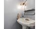 Vintage pedestal sink in a powder room with a decorative mirror and modern lighting at 1420 11Th Street Nw Dr # 15, Hickory, NC 28601