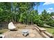 Beautiful backyard patio with stone pavers, seating, and lush landscaping, ideal for relaxation at 16402 Doves Canyon Ln, Charlotte, NC 28278