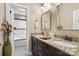 Bathroom boasts double sinks, dark wood cabinets, and granite countertops at 16402 Doves Canyon Ln, Charlotte, NC 28278