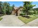 Long driveway leads to a stunning stone home with well-maintained landscaping at 16402 Doves Canyon Ln, Charlotte, NC 28278