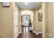 Welcoming foyer with hardwood floors, arched doorways, and a decorative front door at 16402 Doves Canyon Ln, Charlotte, NC 28278