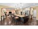 Open-concept kitchen includes an island with pendant lights and seating, flowing into a cozy living space at 16402 Doves Canyon Ln, Charlotte, NC 28278