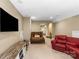 Spacious living room with plush seating, TV, and neutral carpeting at 16402 Doves Canyon Ln, Charlotte, NC 28278