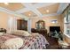 Comfortable main bedroom with hardwood floors, tray ceilings, and ample natural light at 16402 Doves Canyon Ln, Charlotte, NC 28278