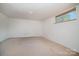 Empty basement room with carpeting and a window overlooking the backyard at 165 Fieldstone Farm Dr, Statesville, NC 28625