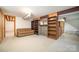 Finished basement area with carpeting, exposed ductwork, built-in shelving, and a couch at 165 Fieldstone Farm Dr, Statesville, NC 28625