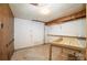 Unfinished basement area with concrete floors and walls, a sink, and wood paneling at 165 Fieldstone Farm Dr, Statesville, NC 28625